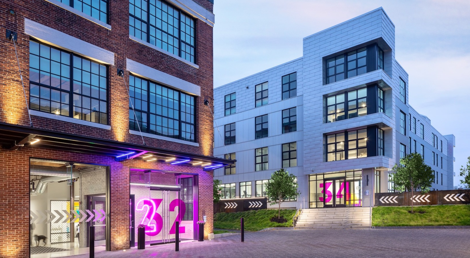 two apartment buildings with neon lights