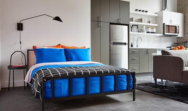 a bedroom with a bed and a chair