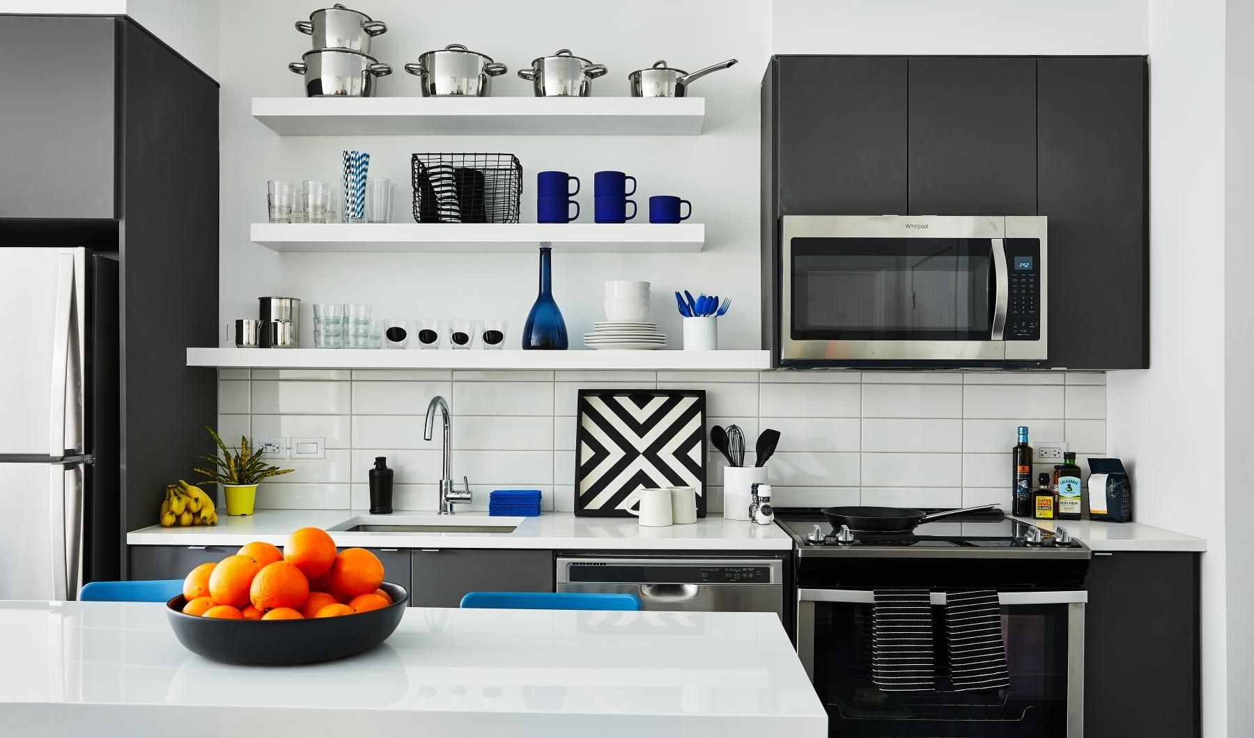 a kitchen with a bowl of fruit on a table